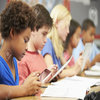 Pupils in class using digital tablet